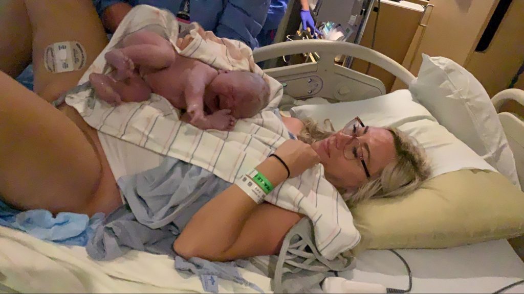 woman with her newborn infant in a hospital bed